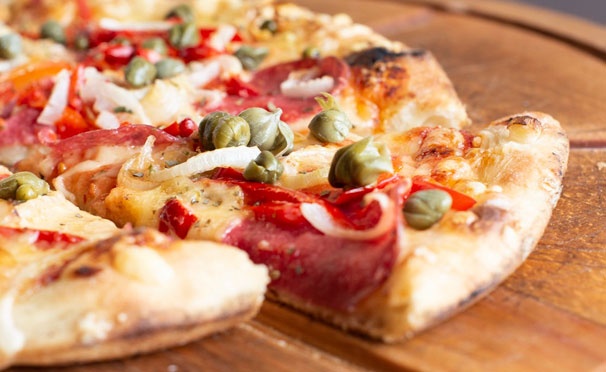 Скидка на Скидка до 68% на доставку итальянской пиццы и осетинских пирогов с тыквой, картофелем, сыром и другими начинками от пекарни «Пицца Торг»